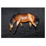 Miniature Breyer Rojo grazing Bay Dun horse
