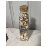 Glass container of sea shells