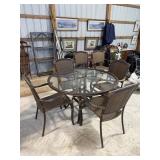 Round outdoor patio table with glass top and 6
