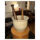 Two antique wooden pestles and a stoneware