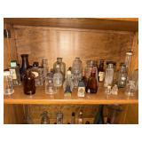Shelf lot of collectible perfume and other bottles
