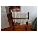 Quilt rack with modern crochet bedspread