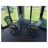 Patio table with 2 chairs and cushions and a