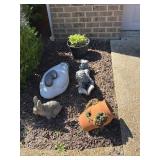 Cement bunny, 2 planters, a child reading a book