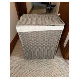 Woven gray rattan laundry hamper, trash can and a