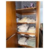 Contents of bedroom closet including sheets,