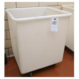 Plastic laundry bins on castors