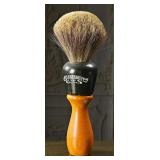 A vintage oversized barber display brush