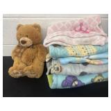 Group of kids throw blankets and teddy bear