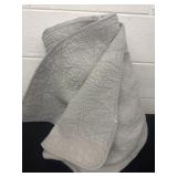 Gray quilt has tear