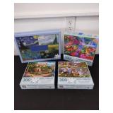 Three 300 count piece puzzles and one 1000 piece