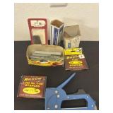 Group of staples with gun