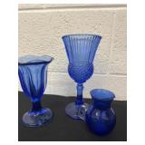 3 blue glass cups and pitcher