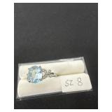 vintage-style ring features a blue oval-cut stone