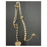 gold-toned necklace featuring white faux pearl