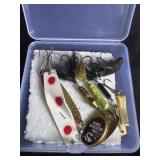 vintage fishing lures in a clear plastic