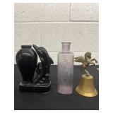 Purple bottle with brass bell and dolphin vase