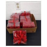 Nine boxes of silk flower petals red in color