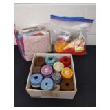Fabric quilting squares, embroidery thread and