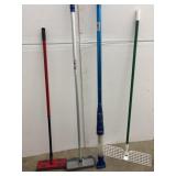 Four cleaning supplies, one swiffer one mop, one