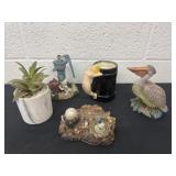 Group of figurines fake plant and drink cup