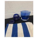 Blue and white towel and glass vase