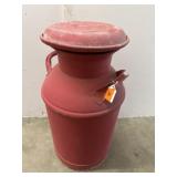 Milk can painted red good condition with a flat