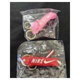 Two Nike keychains, one pink, one red and black