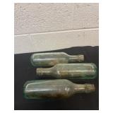 Three 9ï¿½ Antique ginger ale round bottles