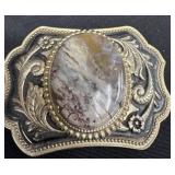 western-style belt buckle featuring an oval