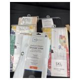 Group of new shower curtains and liners