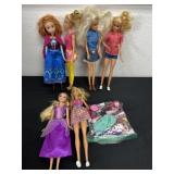 Group of Barbie and Disney dolls with accessories