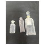 Three antique embossed perfume bottles