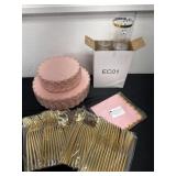 Group of pink and gold party plates and cups and
