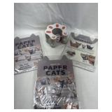 Three packs of paper, cats, and cat toy