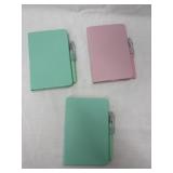 Three tiny notebooks with pens