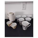 Six coffee mugs, small cups and a picture.  Small