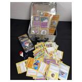 Pokï¿½mon cards in tin with pokemon go plus