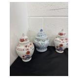 three lidded porcelain jars feature traditional