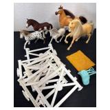 Group of toy  horses with fence