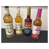 Four bottles of syrup, banana mango, pomegranate