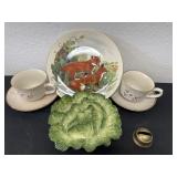 Two Covington stoneware, tea cup, and saucer wolf