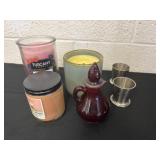 Group of candles, red glass and shot glasses