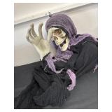 Hanging skeleton with purple and black cape