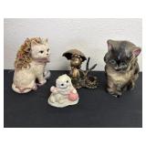 Three cat figurines one is a piggy bank with Lucy