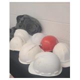 Seven hard hats and green bag