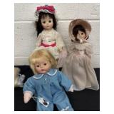 Two porcelain dolls with baby doll