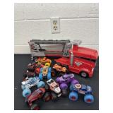 Group of monster trucks with monster jam trailer
