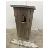 Wooden outhouse with outhouse decorative sign