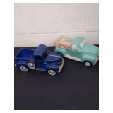 Two10.5-in ceramic trucks one has some paint